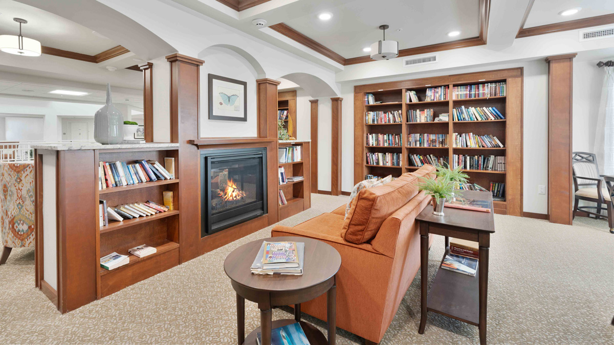 The library at Hessler Heights with shelves of books and comfortable seating
